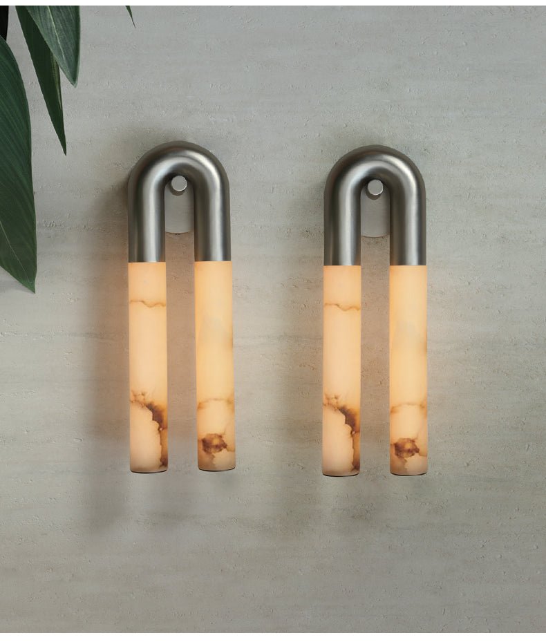 Pair of nickel Arch wall sconces mounted arch-up with the alabaster tubes hanging down, unlit