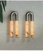 Pair of nickel Arch wall sconces mounted arch-up with the alabaster tubes hanging down, unlit