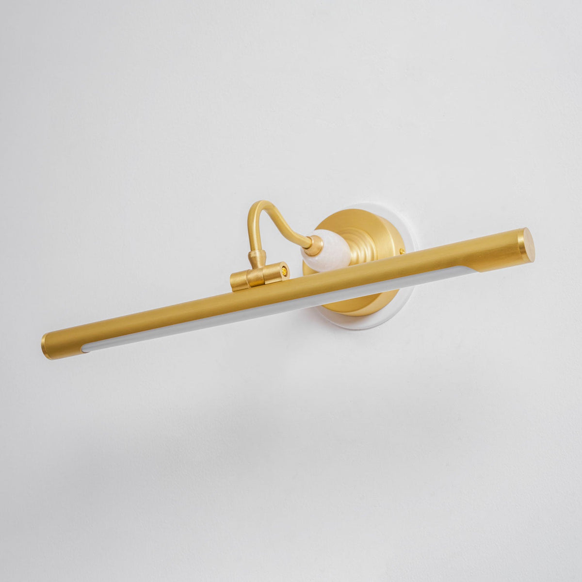 From a different angle, this unlit Clérachic wall sconce in gold shows its curved arm rising to meet the bar.