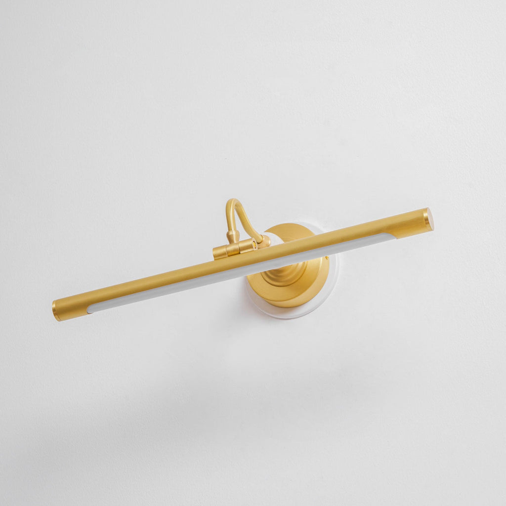 Viewed at an angle, this unlit Clérachic wall sconce in gold shows its curved mounting arm and slim bar.
