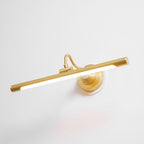 Viewed at an angle, this Clérachic wall sconce in gold glows along its bar, its curved arm connecting to a round wall plate.