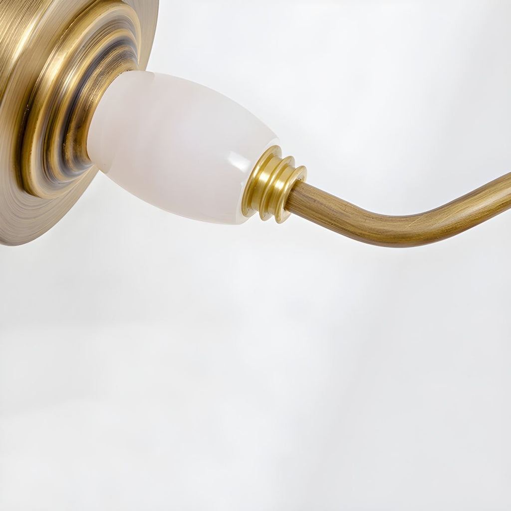 Close view of the porcelain finial and gold swivel joint on this Clérachic wall sconce.
