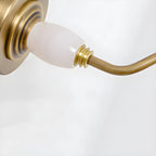 Close view of the porcelain finial and gold swivel joint on this Clérachic wall sconce.