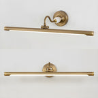 This Clérachic wall sconce in gold is pictured twice, straight-on above and at an angle below, showing its curved mounting arm.