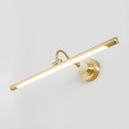 Viewed at an angle on a plain grey background, this Clérachic wall sconce in gold glows along its acrylic shade.