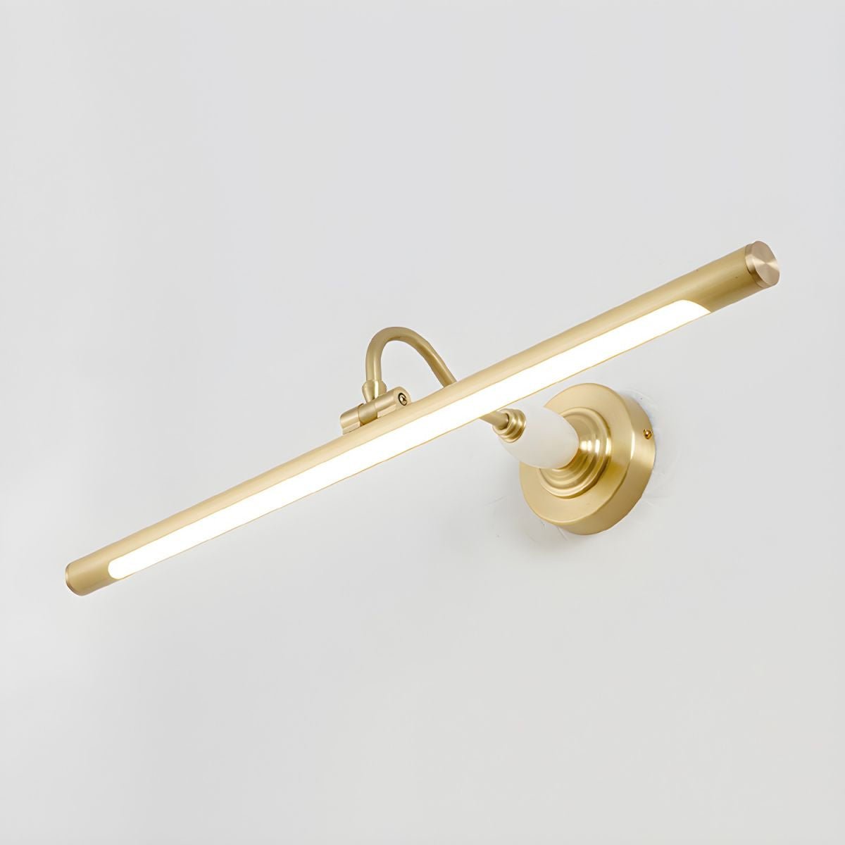 Viewed at an angle on a plain grey background, this Clérachic wall sconce in gold glows along its acrylic shade.