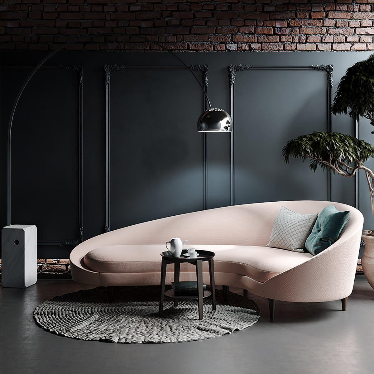 Against a dark panelled accent wall, the Clérachic arc lamp curves above a blush curved sofa and a potted olive tree.