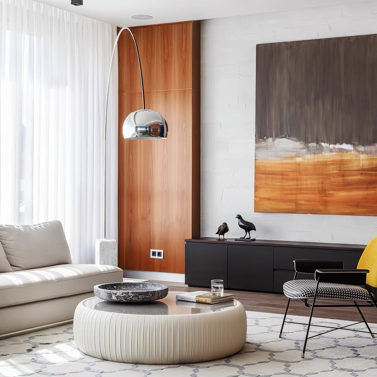 A closer view shows the Clérachic arc lamp's chrome dome against the walnut panel wall beside a striped cream sofa arm.