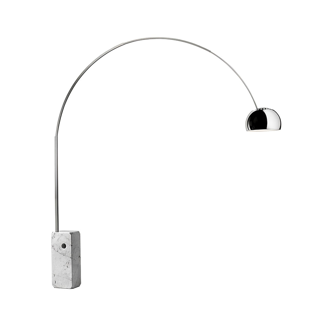 A Clérachic arc floor lamp stands on a plain grey backdrop, its polished chrome dome and marble base catching soft studio light.