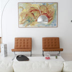 The Clérachic lamp's chrome dome is set against a large abstract painting, its marble base beside two tan leather Barcelona chairs.