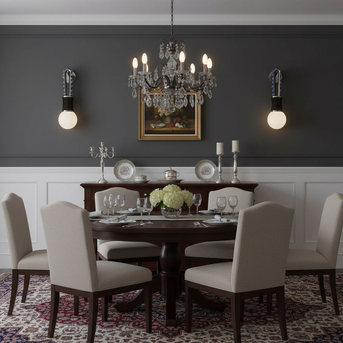 In a dark grey dining room, a crystal chandelier hangs above the table between two lit Clérachic wall sconces.