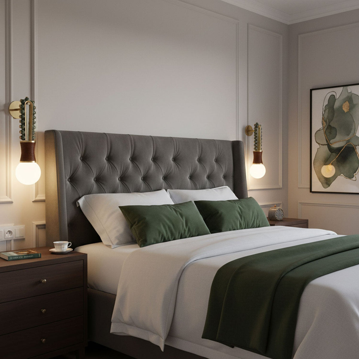 Green cushions dress the bed below a grey tufted headboard flanked by two lit Clérachic wall sconces.