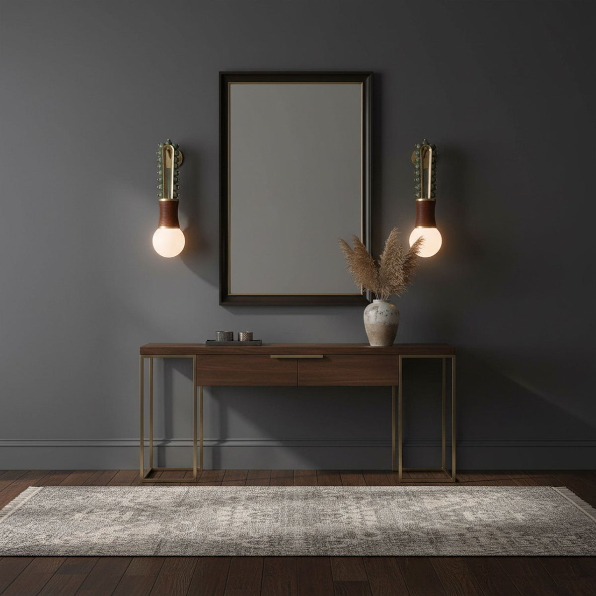 A mirror above a console table sits between two lit Clérachic wall sconces in a dark blue-grey room.