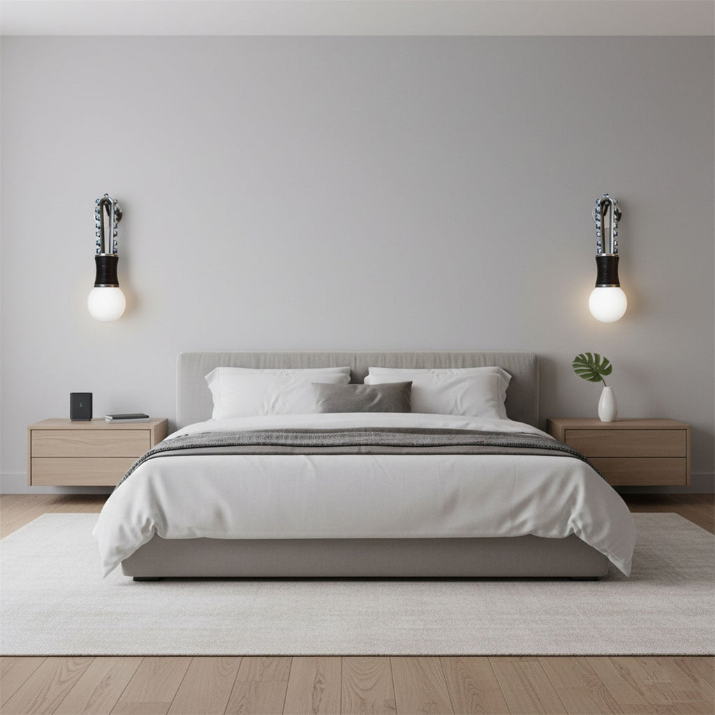 Wood nightstands flank a low platform bed lit either side by two Clérachic wall sconces in a neutral grey bedroom.