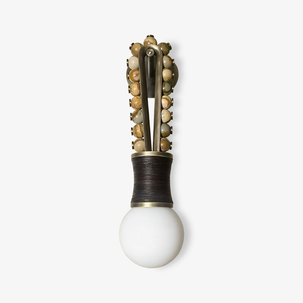 Clérachic wall sconce with mixed grey and tan stone beads on a brass frame and a black-wrapped base, on a white background.
