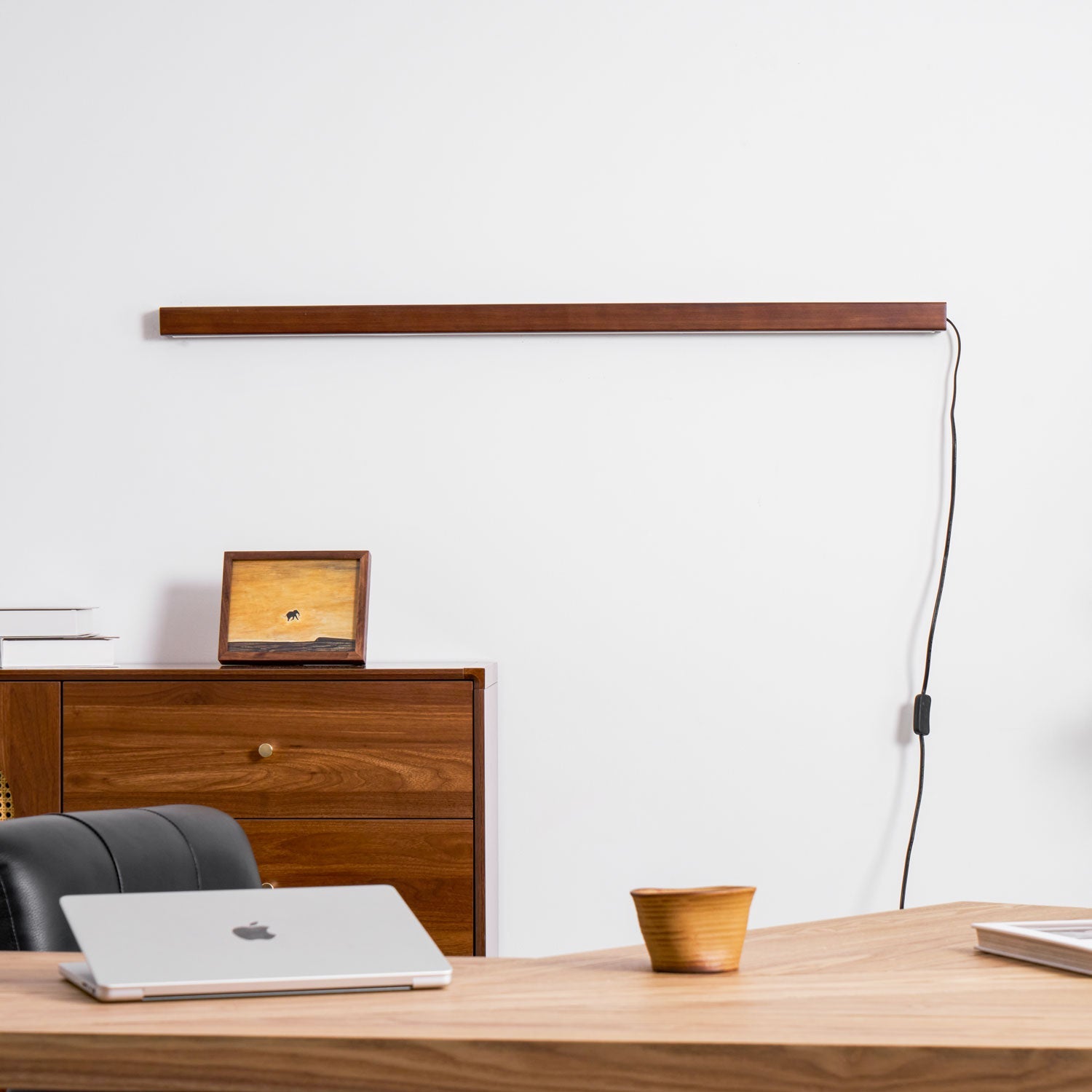 Walnut wood wall light shown close up of its rim