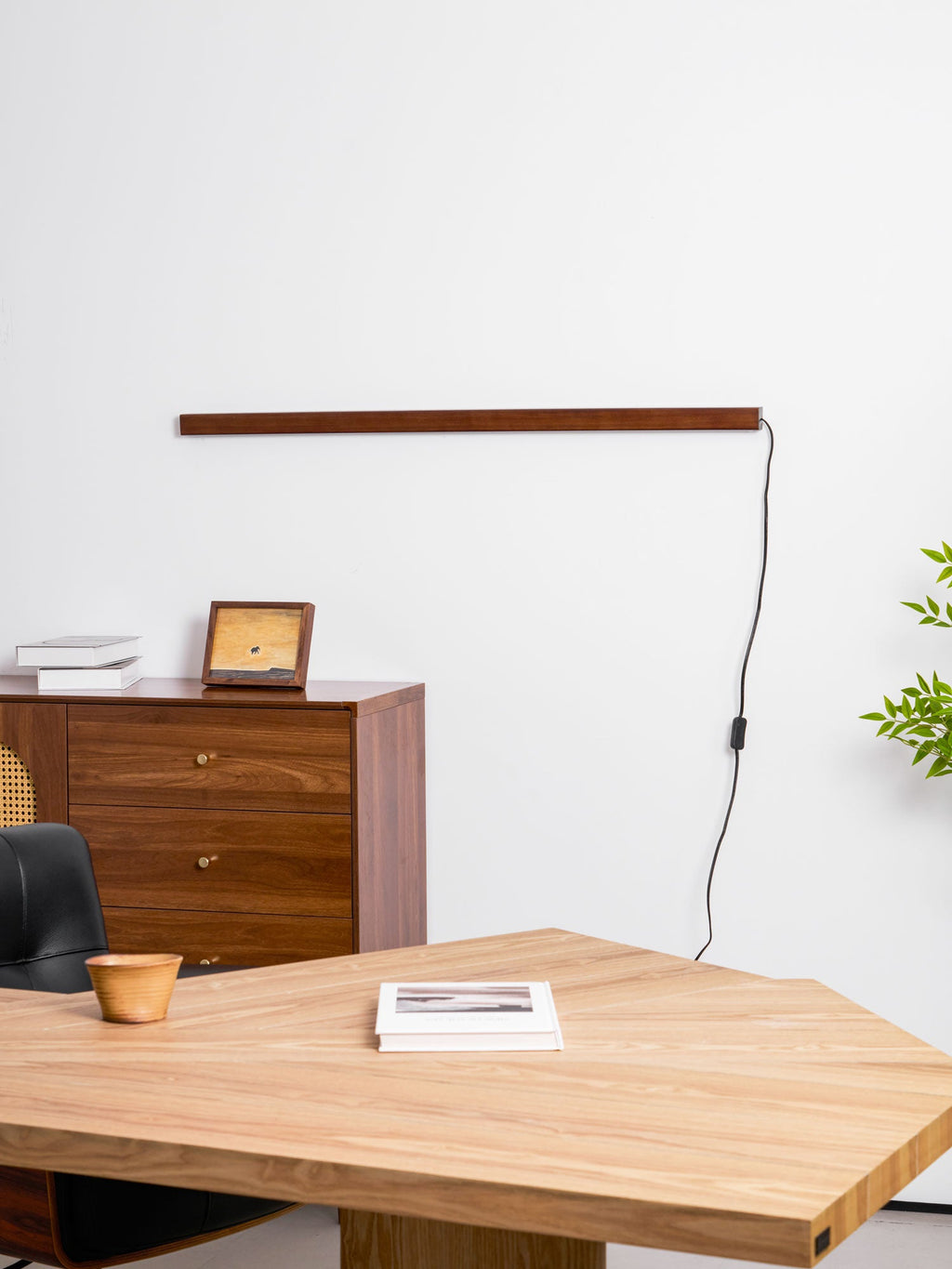 Round wood wall light mounted above a seating area