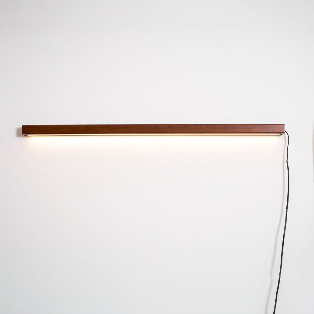 Pine wood disc wall light shown from the side