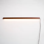 Pine wood disc wall light shown from the side