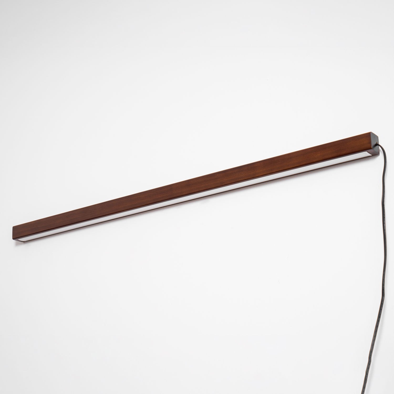 Round wood wall light shown lit as a feature accent