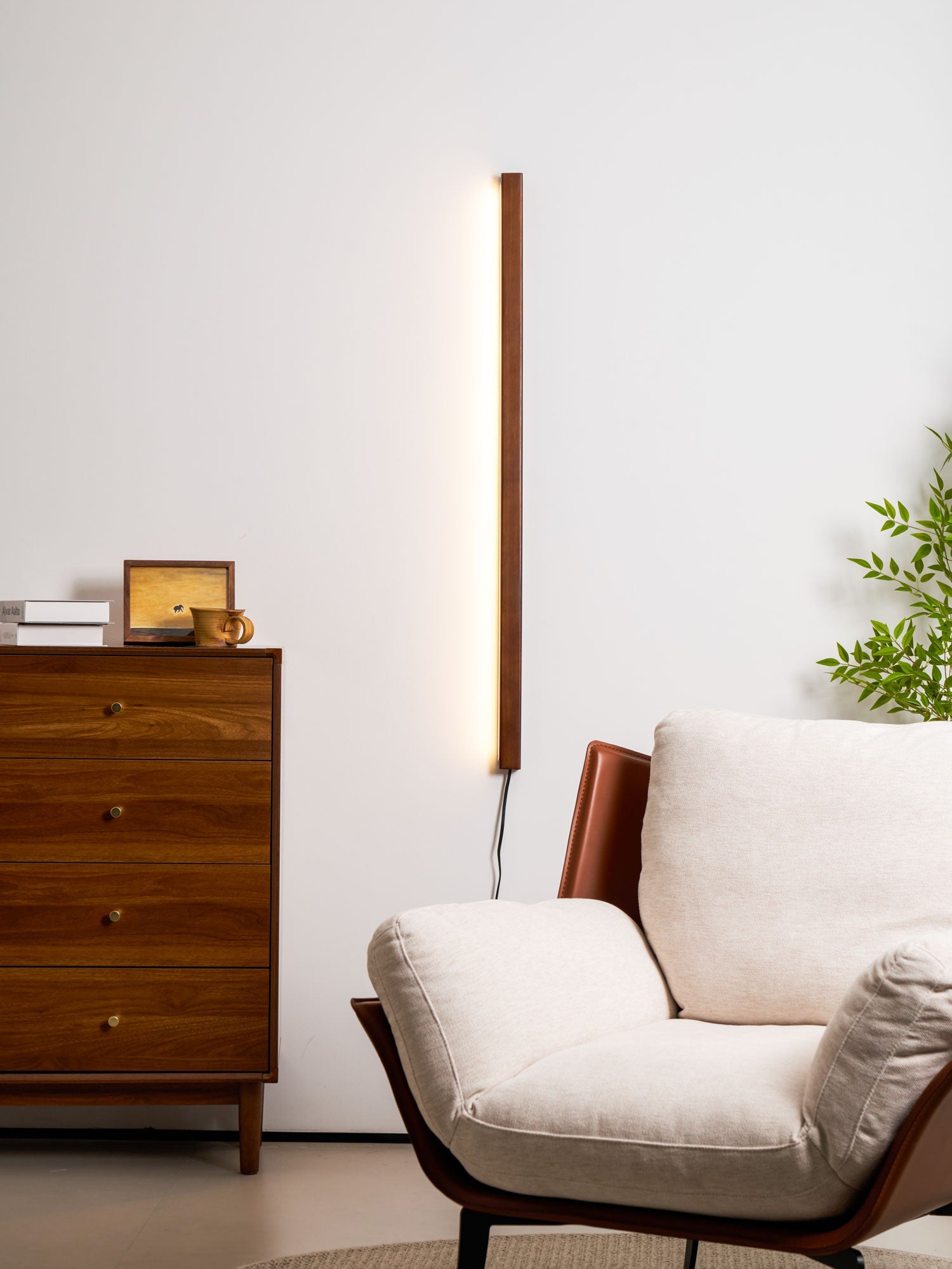 Slim wood disc wall light mounted on a textured wall