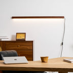 Pine wood disc wall light shown against a neutral backdrop