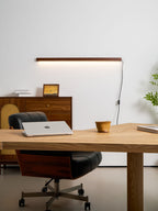 Pine wood disc light glowing warmly above a console