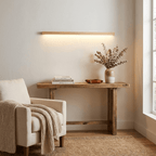 Wooden linear wall light with frosted shade shown front-on