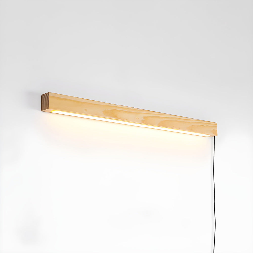 Slim pine wood disc wall light glowing on a hallway wall