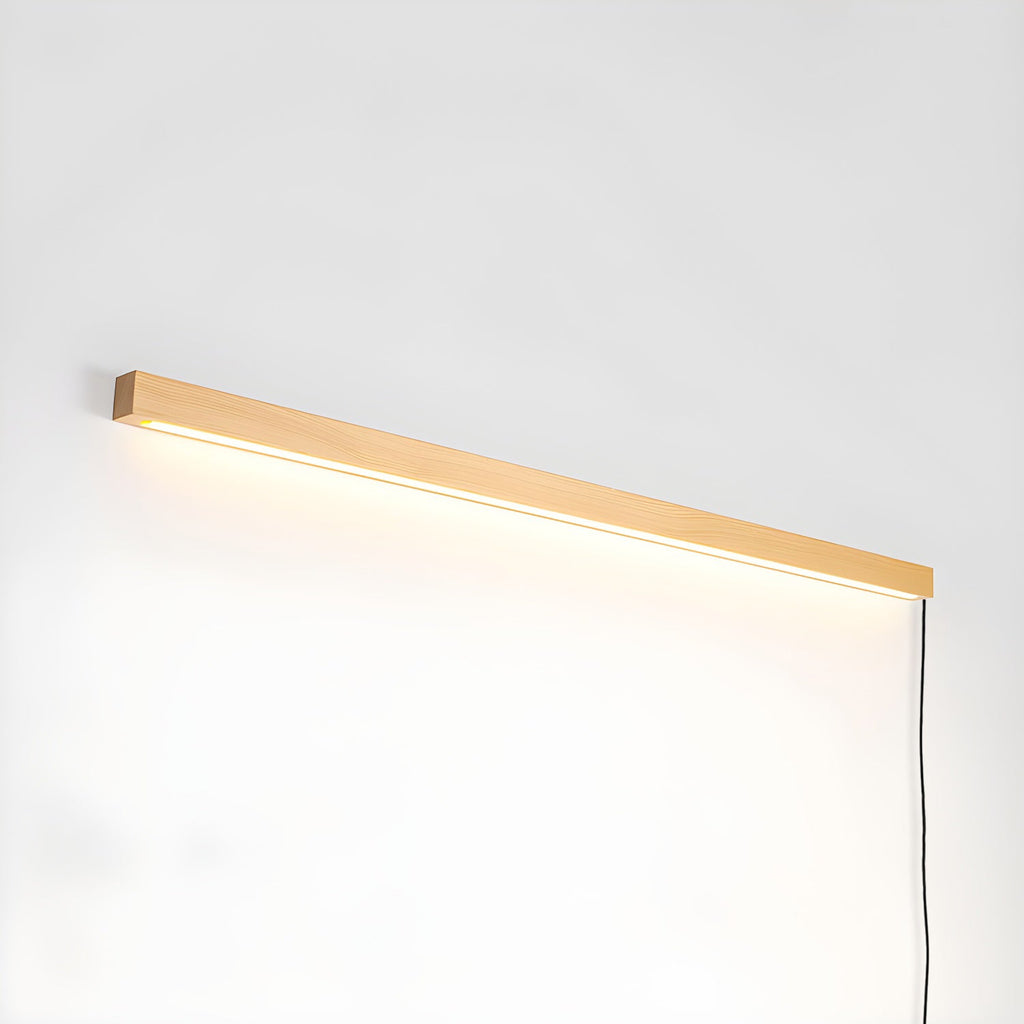 Pine wood disc light glowing softly above a mirror