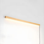 Pine wood disc light glowing softly above a mirror