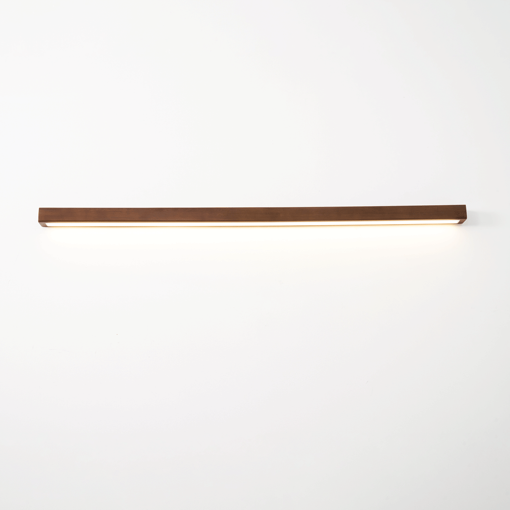 Pine wood wall light illuminating an entryway softly