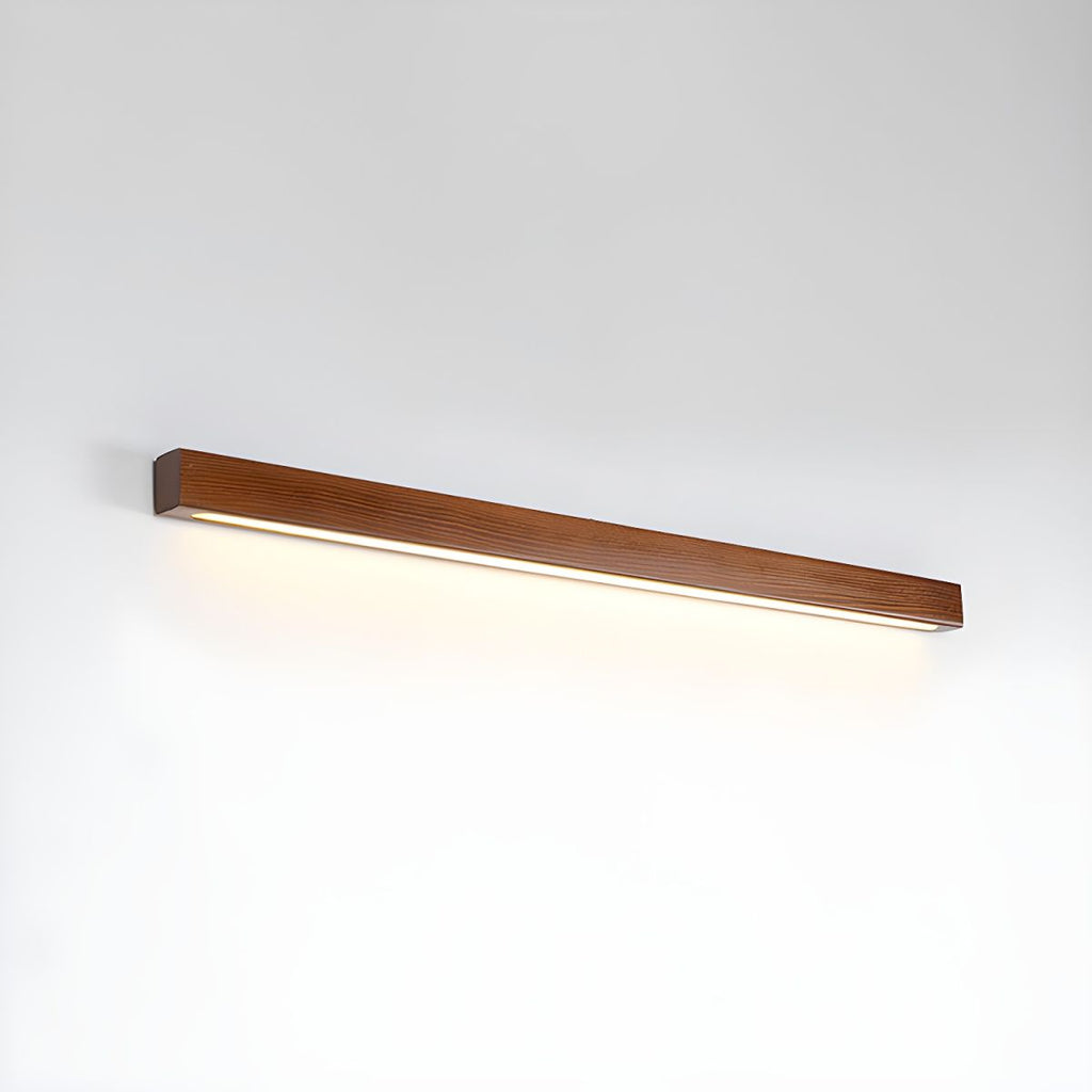 Linear wooden wall sconce shown in a styled interior