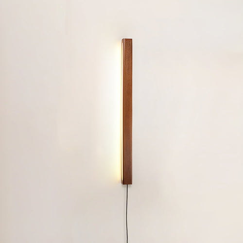 Pine wood disc wall light casting a clean bright glow