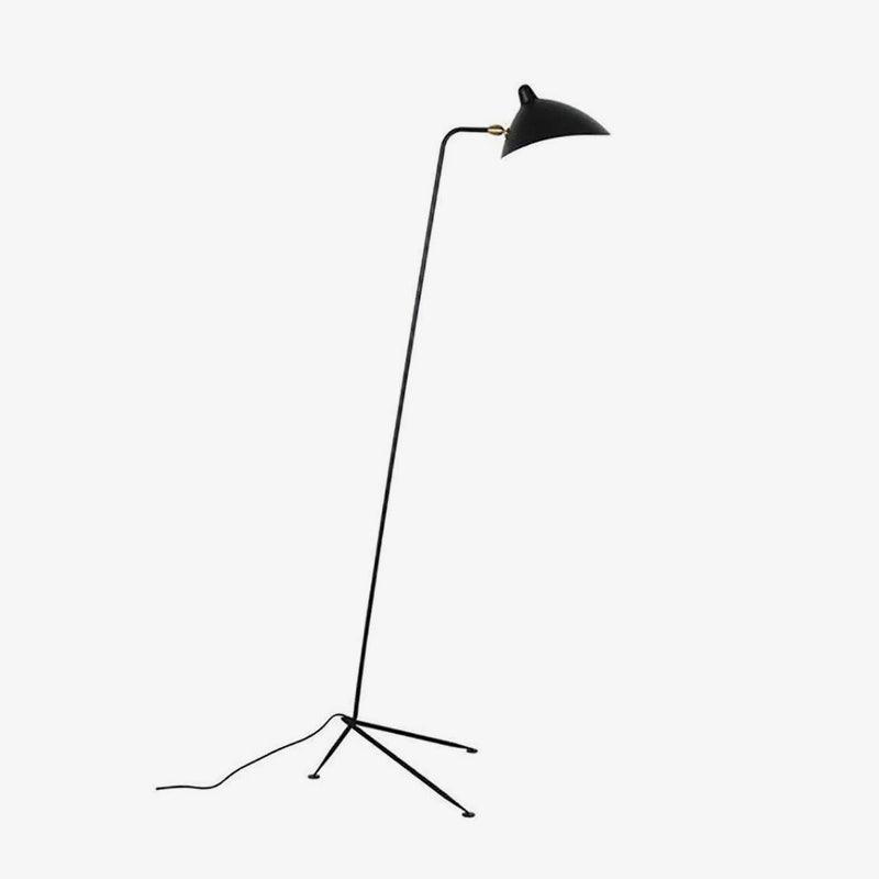 Close view of this Clérachic floor lamp's brass pivot joint and slender black arm against a plain backdrop.