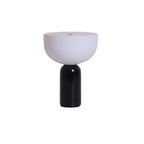 The black marble base and white dome shade of this Clérachic table lamp, isolated on a white background.