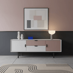 Clérachic's marble sphere lamp lit atop a two-tone cabinet, with framed art above and small vases nearby.