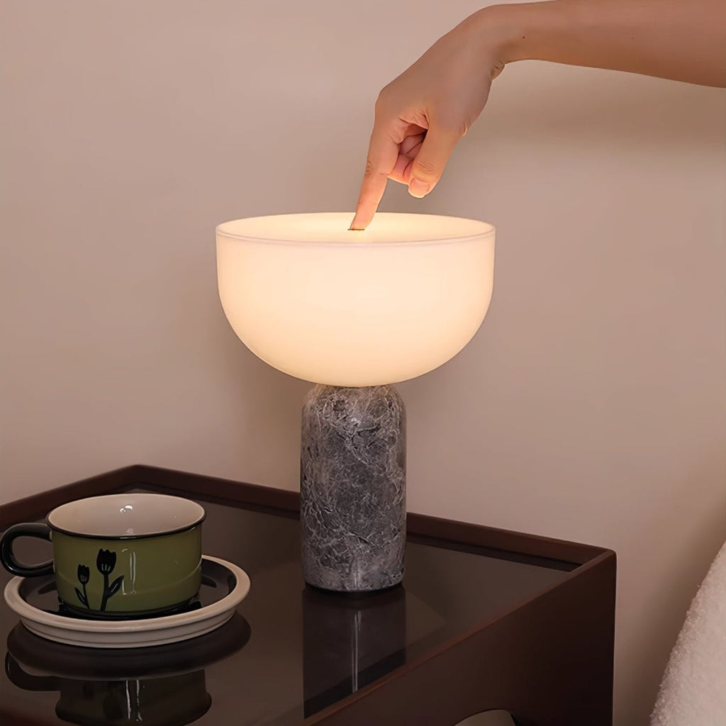 A fingertip touches the glass dome of this Clérachic table lamp, demonstrating its touch-control switch.