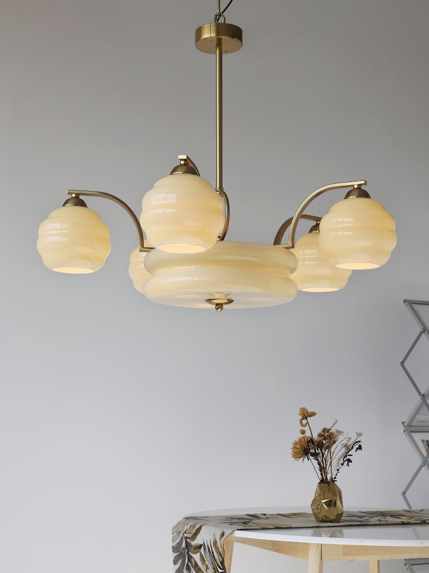 Art Deco chandelier shown lit in a warm interior