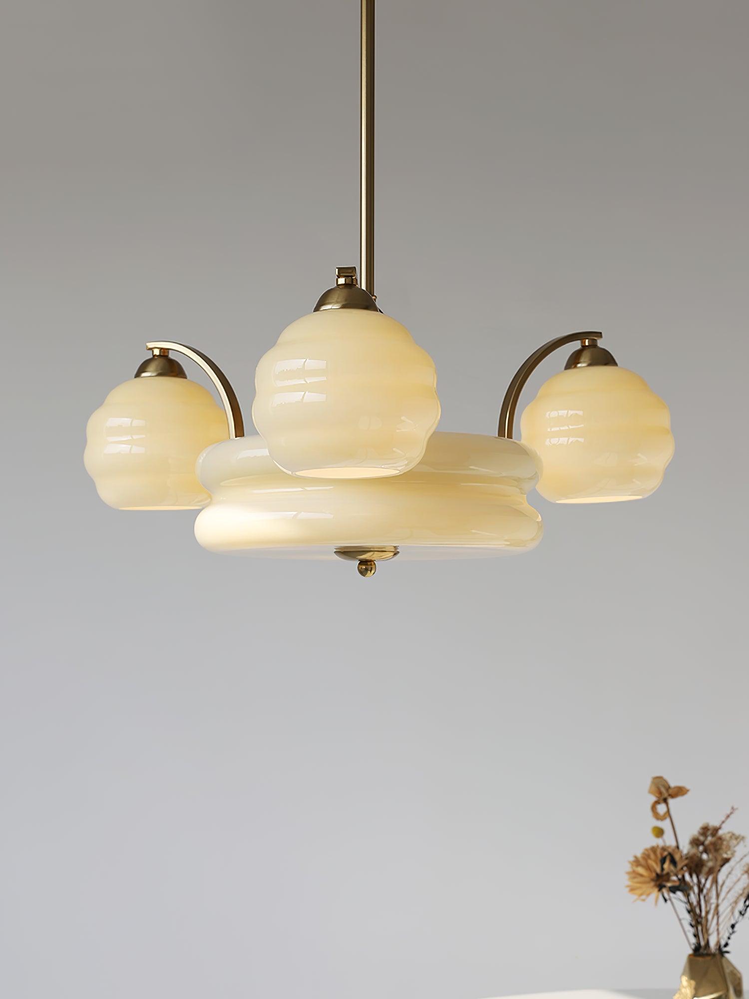 Art Deco chandelier with curved glass shades lit warmly