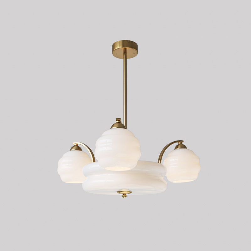 Art Deco chandelier glowing warmly with frosted glass shades