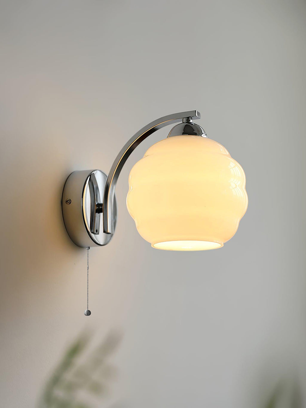 Vintage glass shade wall lamp lighting a cosy reading nook