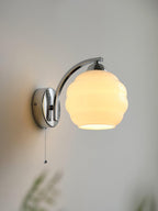 Vintage glass shade wall lamp lighting a cosy reading nook