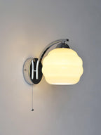 Art Deco wall sconce shown beside framed wall art