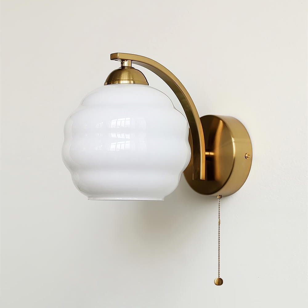 Art Deco wall sconce with curved glass shade mounted on wall
