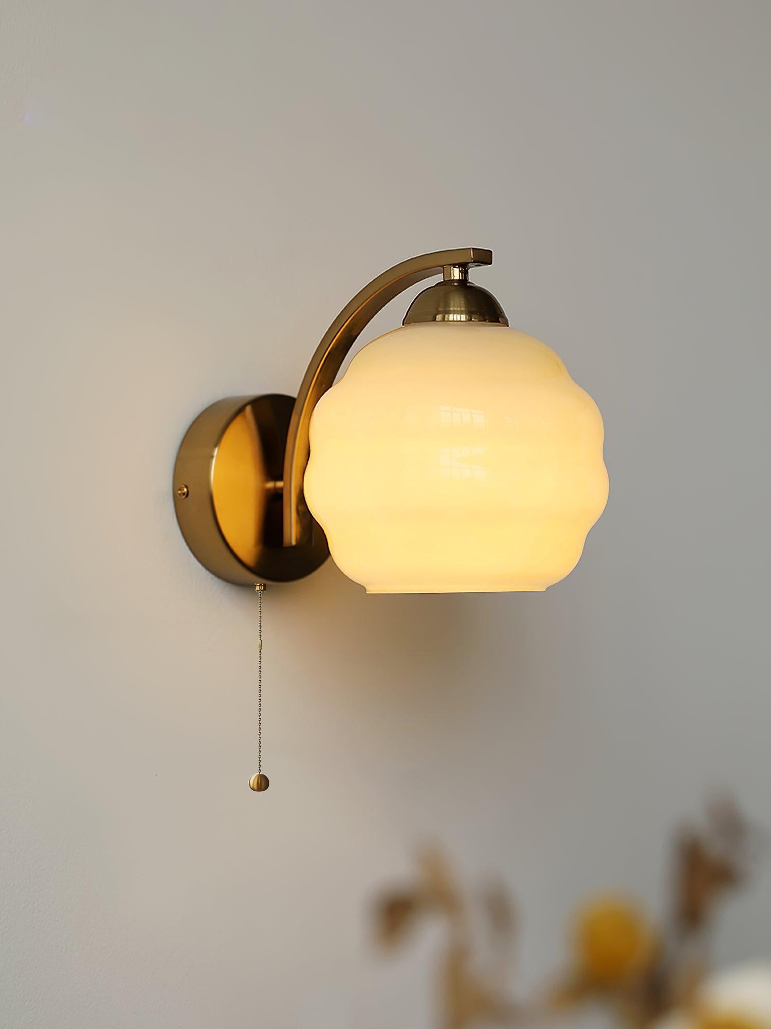 Art Deco wall sconce with warm filament bulb glowing softly