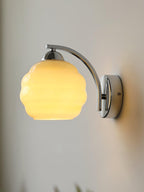 Art Deco wall sconce glowing softly on a wall