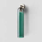 Mouthblown glass wall light glowing in a warm room setting