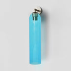 Slim cylindrical glass wall sconce with metal base, side view