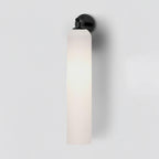 Cylindrical glass wall light with metal hardware, detail shot